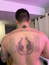 a man with a tattoo on his back